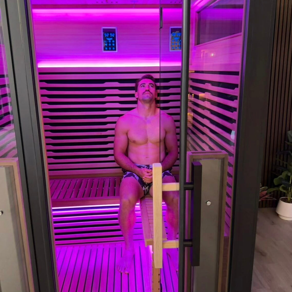Connor Watson relaxing inside the Bella Deluxe infrared sauna with chromotherapy lighting